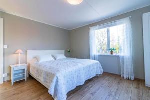 a bedroom with a bed and a large window at KRO803-Haeradsbaeck-Ellagoelshult-4 in Häradsbäck +3 photos