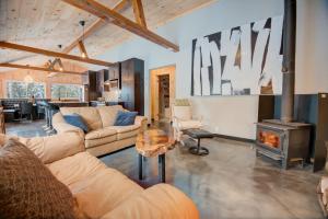 a living room with couches and a wood stove at Spa by Lake Edja - Chalet Yellow Mellow in Messines