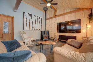 a living room with two couches and a tv at Spa by Lake Edja - Chalet Yellow Mellow in Messines