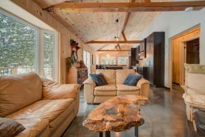 a living room with two couches and a table at Spa by Lake Edja - Chalet Yellow Mellow in Messines +37 photos