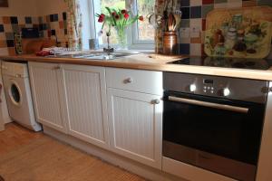 a kitchen with a sink and a stove top oven at South Lodge in Lochgilphead +13 photos