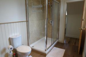 a bathroom with a shower and a toilet at School Room in Lochgilphead