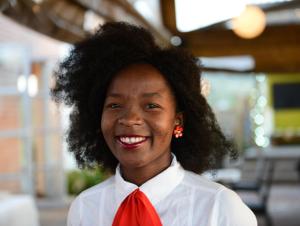 a woman wearing a white shirt and a red tie at Hokahanya Inn & Conference Centre in Maseru