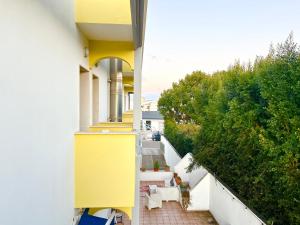 an external view of a building with a yellow wall at Residence Perla - Costa in Salve