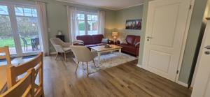 a living room with a couch and a table at Perlmuschel in Borkum