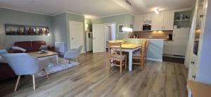 a living room and kitchen with a table and chairs at Perlmuschel in Borkum
