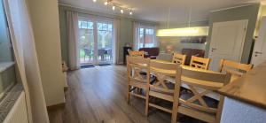a dining room and living room with a table and chairs at Perlmuschel in Borkum