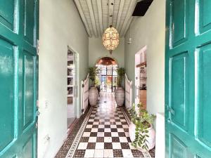 a hallway with a checkered floor and a chandelier at Habitacion olas altas in Mazatlán
