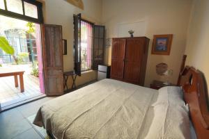 a bedroom with a bed and a large window at Habitacion Faro in Mazatlán +4 photos