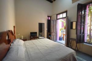 a bedroom with a large bed and a window at Habitacion Faro in Mazatlán