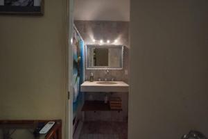 a bathroom with a sink and a mirror at Habitacion Machado in Mazatlán