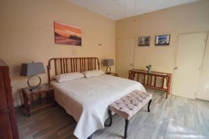 a bedroom with a large bed and two night stands at Habitacion Machado in Mazatlán