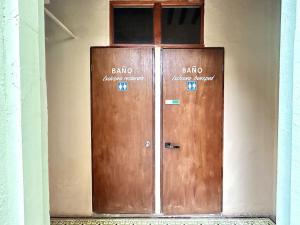 two wooden doors with the words bjo on them at Habitacion Carnaval in Mazatlán +5 photos