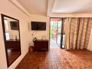 a room with a hallway with a door to a patio at Habitacion Carnaval in Mazatlán
