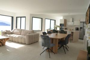a living room with a table and a couch at villa la baies des anges in Calcatoggio