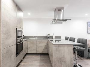 a kitchen with a sink and a microwave at Casa Fresa - Castlehill Apartment in Dundee