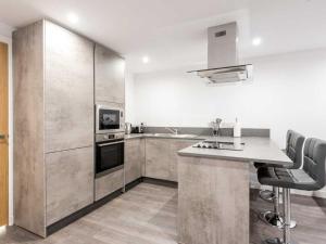a kitchen with stainless steel appliances and a counter at Casa Fresa - Castlehill Apartment in Dundee