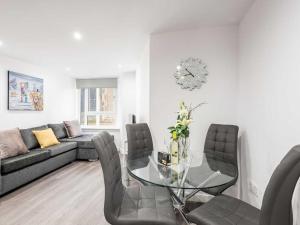 a living room with a glass table and a couch at Casa Fresa - Castlehill Apartment in Dundee