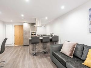 a living room with a couch and a kitchen at Casa Fresa - Castlehill Apartment in Dundee +44 photos