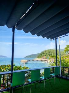 a balcony with chairs and a view of the ocean at Tuan Thanh Homestay in Tân Hiệp
