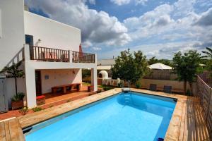 a swimming pool in front of a house at Villa Ca Paulina in San Antonio