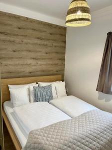 a bedroom with a large bed with a wooden headboard at Harmónia Panzió in Bogács