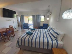 a bedroom with a bed and a table and chairs at Crayfish Inn no5 in Ramsgate