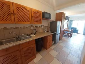 a kitchen with a sink and a refrigerator at Crayfish Inn no5 in Ramsgate
