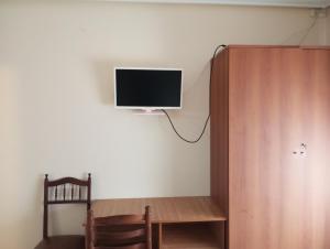 a room with a desk and a tv on a wall at Hostal Isabel in Bronchales