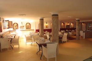 a dining room with tables and white chairs at Pasta Plaza in Asilah