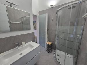 a bathroom with a white sink and a shower at FRANCIACORTA LAKELAND Lodge in Capriolo +23 photos