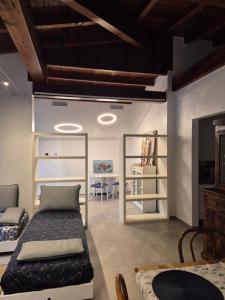 a living room with two beds and a couch at FRANCIACORTA LAKELAND Lodge in Capriolo