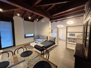 a living room with a couch and a table at FRANCIACORTA LAKELAND Lodge in Capriolo