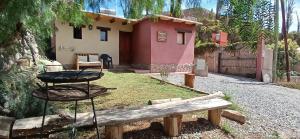 a small house with a table in front of it at Cabañas La Esther Tilcara in Tilcara