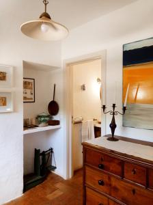 a room with a wooden dresser and a mirror at Monte das Andorinhas Alentejo in Montemor-o-Novo +31 photos