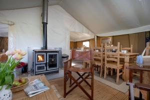 a tent with a dining room and a fireplace at Cuckoo - Sweffling Hall in Rendham