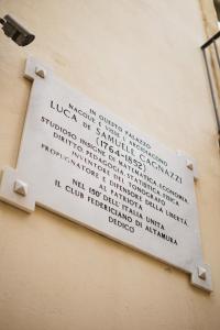 a sign on the side of a building at Hotel San Nicola in Altamura