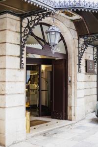 an entrance to a building with a light above a door at Hotel San Nicola in Altamura