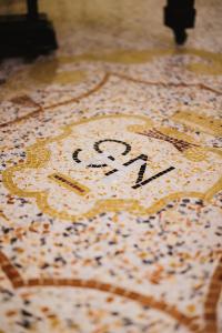 a clock on the floor with the on it at Hotel San Nicola in Altamura +47 photos