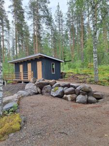 a small cabin in the middle of a forest at Beautiful Cottage at Lake Saimaa, Rantamaja in Juva