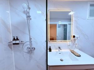 a bathroom with a sink and a shower with a mirror at Lanta Forest Resort & Villas in Ko Lanta Yai +141 photos