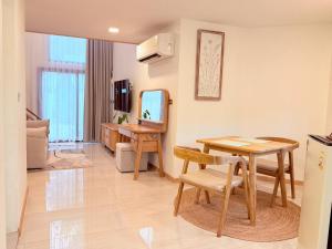 a living room with a table and a mirror at Lanta Forest Resort & Villas in Ko Lanta Yai