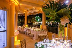 a dining room with tables and chairs and flowers at Eau Resort & Spa in South Palm Beach +120 photos