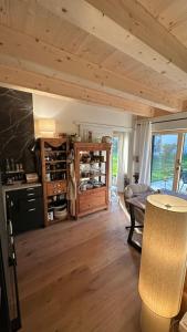 a living room with a wooden ceiling and a table at 5 Sterne Ferienwohnung Villa Barka in Eppenschlag +54 photos