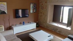 a living room with a white couch and a window at Apartamento Rural Sorribos (VUT-CO-004306) in Muros