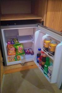 an open refrigerator filled with food and drinks at Jkl MahaOya Villa in Wayikkal