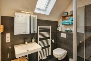 a bathroom with a sink and a toilet at Ferienwohnungen Etzl in Bad Mergentheim +17 photos