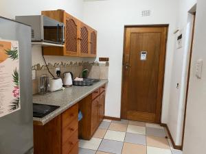 a kitchen with a sink and a refrigerator at Crayfish Inn no6 in Ramsgate