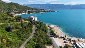 an aerial view of a beach with a building on a hill at La Dimora Azzurra in Vlorë