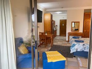 a room with two beds and a dining room with a table at Crayfish Inn no6 in Ramsgate